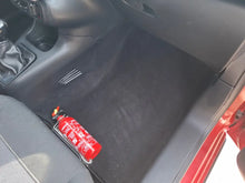 Red fire extinguisher mounted by Citroen C3 PureTech seat