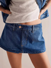 Classic wash denim mini skort in blue with button closure and front pockets made from durable denim material