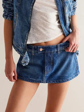 Blue denim mini skort with button closure and side pockets in classic wash denim mini style