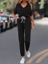 Black cold-shoulder jumpsuit with white drawstring waist, machine wash cold
