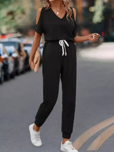Black cold-shoulder jumpsuit with white drawstring waist, machine wash cold