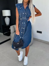 Black prada handbag with silver chain strap and triangular logo paired with collared neck cap sleeve denim dress