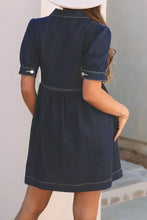 Navy blue denim dress with collared neck half zip, short puffed sleeves, and white stitching details