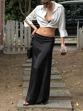 Black satin maxi skirt paired with a collared neck long sleeve cropped shirt perfect for elegant occasions