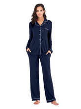 Navy blue collared neck long sleeve loungewear set with white piping and pockets highlighting sleeve length design