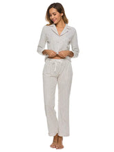 White collared neck loungewear set with subtle polka dot pattern, long sleeve length, drawstring pants, and pocket