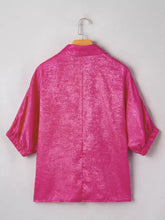 A vibrant fuchsia collared v neck half sleeve metallic satin top with subtle textured pattern and three-quarter sleeves
