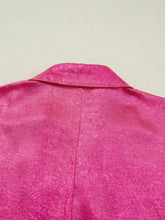 A vibrant fuchsia collared v neck half sleeve metallic top with subtle textured fabric and classic notched collar