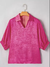 A vibrant pink textured half sleeve metallic blouse with a collared v neck and three-quarter length sleeves