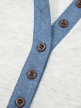 Long sleeve color block button top with blue denim button placket and brown block buttons on light gray fabric