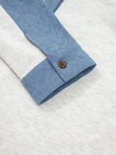 Blue denim long sleeve top with color block button detail featuring white panel and brown cuff button