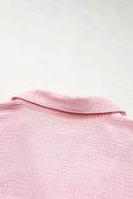 A soft pink textured cotton color block casual button up shirt with a neatly folded collar
