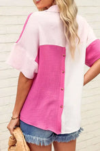 Back view of a vibrant pink and white color block casual button up shirt with textured fabric and flutter sleeves