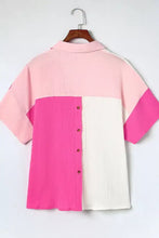 A vibrant pink and white color block casual button up shirt with textured ribbed fabric and short sleeves