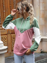 A soft slightly stretchy color block casual long sleeve hoodie in mint green white and dusty pink with a drawstring hood