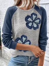 Gray and navy blue color block raglan sleeve sweatshirt features embroidered floral patches with a textured layered design