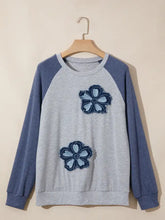 Gray and navy blue raglan sleeve sweatshirt featuring embroidered floral patches on the front for casual wear