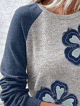 Gray and navy blue color block raglan sleeve sweatshirt features embroidered floral patches with heart-shaped details