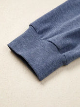 Blue heathered cotton sleeve with ribbed cuff features embroidered raglan sleeve on a color block flower top