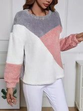 Color block fuzzy knit sweatshirt in gray white and pink with geometric pattern and care instructions for tumble dry use with ankle boots