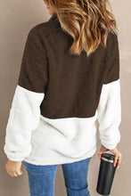 Woman in color block half zip long sleeve fuzzy sweatshirt with jeans and mug