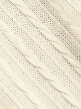 Cream-colored cable-knit sweater dress with textured interwoven pattern