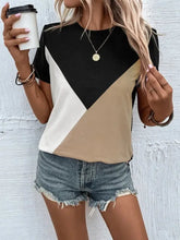 Color block short-sleeve t-shirt in black, white, tan geometric design with distressed denim shorts