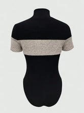 Black and beige color block turtleneck ribbed bodysuit with short sleeves and textured fabric for stylish layering