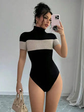 Black and beige ribbed knit color block turtleneck bodysuit with short sleeves in a one-piece design