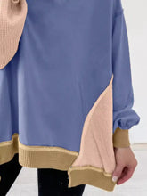 A soft blue and beige color block waffle knit long sleeve sweatshirt with ribbed trim machine wash cold recommended