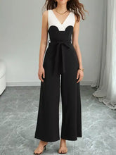 Black and white color block wide leg jumpsuit with V-neck and belted waist