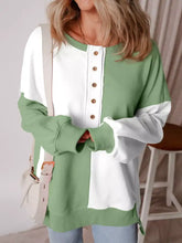 Colorblock henley high low oversize sweatshirt in soft two-tone green and white with button-down front machine wash care instructions