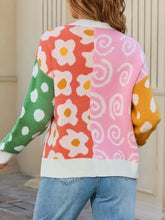 Colorful open front cardigan with orange daisies, pink swirls, green polka dots