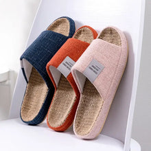 Three colorful open toe flats slippers in blue, orange, and pink