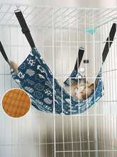 Comfortable hanging pet hammock with blue fabric, white cat prints, durable nylon straps