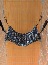 Comfortable hanging pet hammock with white cat in black fabric cage