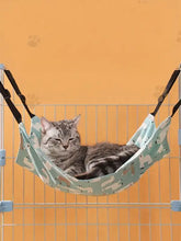 Comfortable hanging pet hammock in light blue with paw prints, durable nylon straps