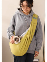 Olive-green pet carrier sling with cozy pouch and adjustable strap