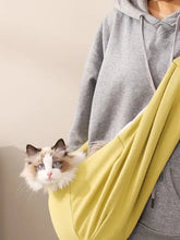Vibrant yellow pet carrier sling bag worn over shoulder