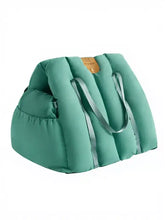 Teal puffer portable pet car nest bag with gray straps and tan leather patch