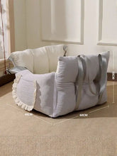 Light gray quilted pet car seat with lace trim and shoulder straps