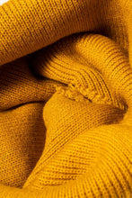 Close-up of mustard yellow Confetti Rib-Knit Cuff Beanie fabric with ribbed texture