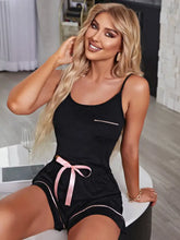 Black contrast cami and shorts lounge set with pink satin ribbon belt and piping details in a pajama style