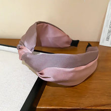 Pink and purple contrast cloth headband with knotted satin design