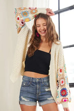 Beige contrast crochet open long sleeve cardigan with floral patterns and distressed denim shorts