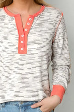 Contrast long sleeve white henley top with black stripes and coral trim