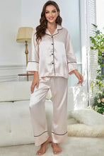 A soft blush satin contrast piping button-up pajama set with long sleeve length and black trim on collar cuffs and hems