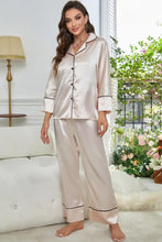 A blush pink satin contrast piping button-up top and pants pajama set featuring long sleeve length details