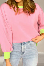 Pink contrast round neck long sleeve sweatshirt with neon green trim and jeans
