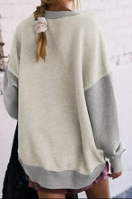 Woman in contrast round neck long sleeve sweatshirt